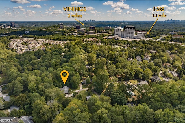 birds eye view of property with a forest view