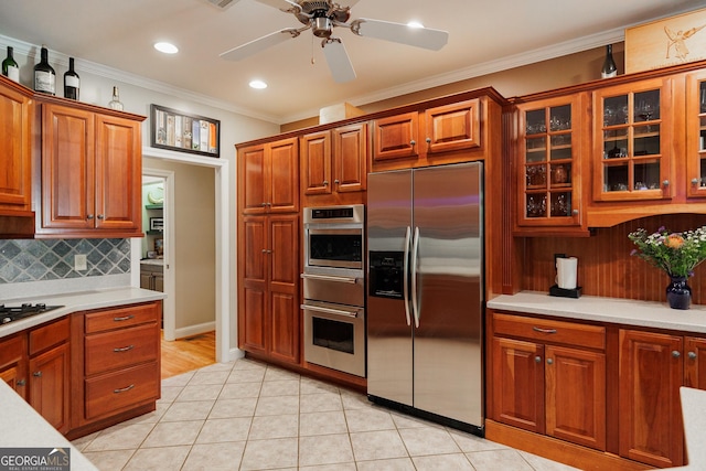 kitchen featuring light tile patterned flooring, light countertops, ornamental molding, stainless steel refrigerator with ice dispenser, and backsplash