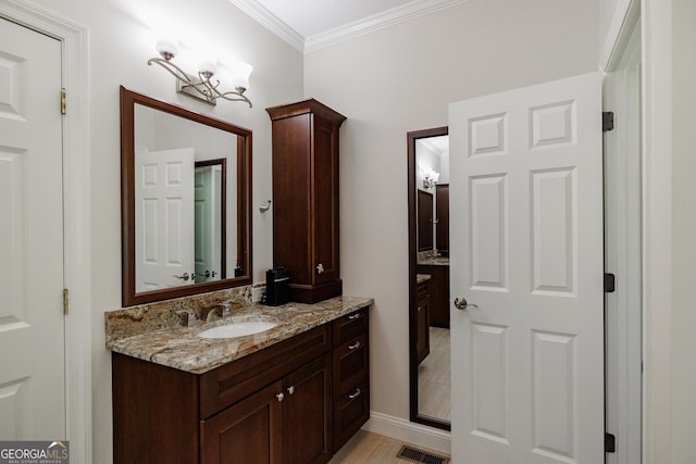 bathroom featuring visible vents, crown molding, and vanity