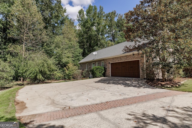 view of front of house featuring a garage, decorative driveway, and brick siding