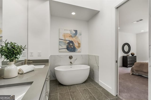 241 Maynard Ter SE Unit 15, Atlanta, GA 30316 - bathroom with double vanity, a freestanding bath, visible vents, and a sink