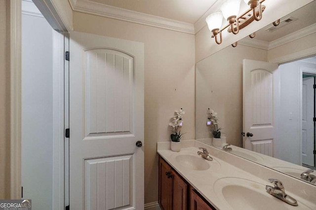 bathroom with ornamental molding and a sink