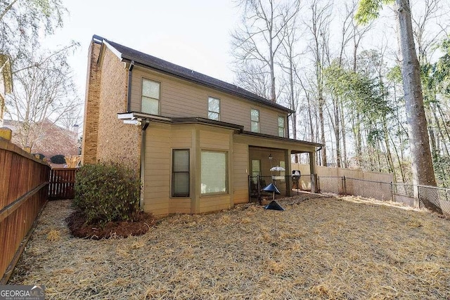 back of property featuring a fenced backyard