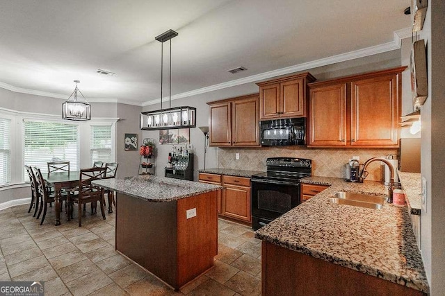 kitchen featuring black appliances, brown cabinets, a sink, and a center island