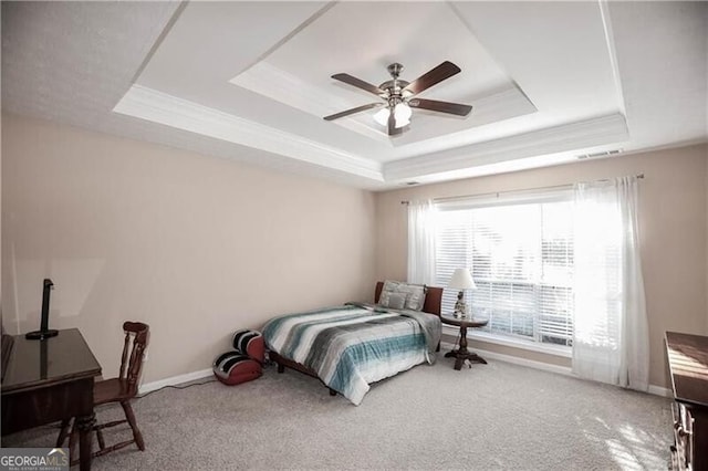 bedroom with carpet floors, a ceiling fan, baseboards, ornamental molding, and a raised ceiling