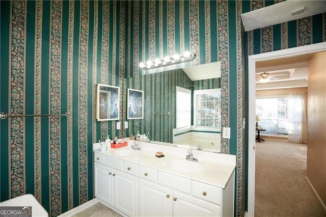 full bath featuring a sink, a bathtub, and wallpapered walls