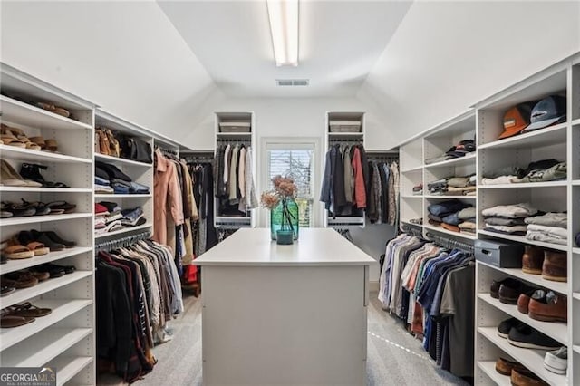 spacious closet with visible vents and vaulted ceiling