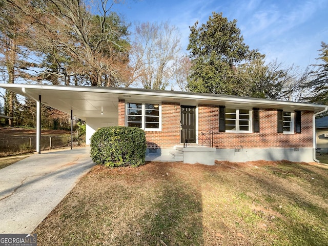 ranch-style house with a carport, crawl space, and brick siding