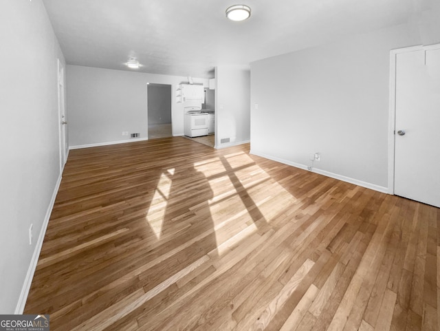 unfurnished bedroom with baseboards, visible vents, and light wood finished floors