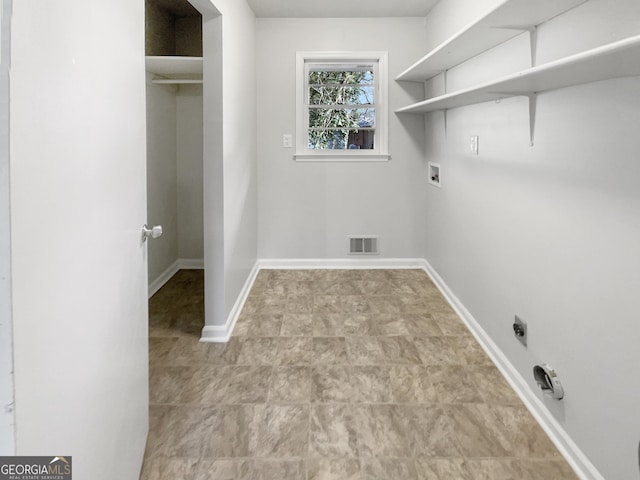 laundry room with laundry area, washer hookup, visible vents, and baseboards