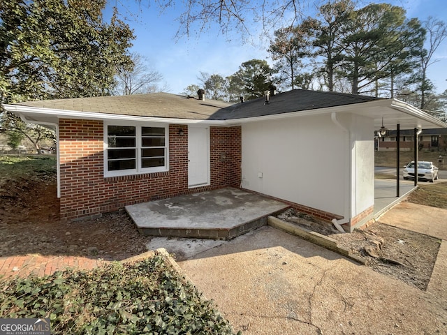 view of front facade with a patio area and brick siding