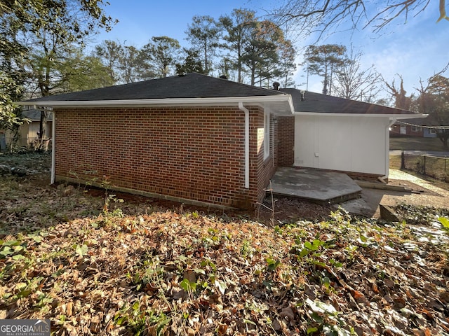 view of property exterior with brick siding