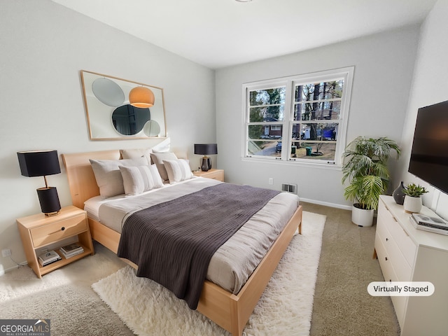 carpeted bedroom featuring baseboards and visible vents