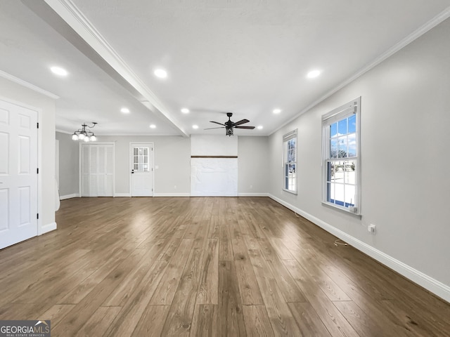 unfurnished living room with recessed lighting, ornamental molding, wood finished floors, baseboards, and ceiling fan with notable chandelier