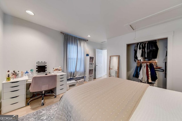 bedroom with light wood finished floors, attic access, a closet, and recessed lighting