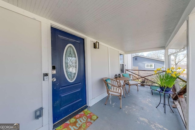 view of exterior entry featuring a porch