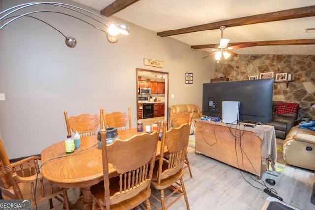 dining area with lofted ceiling with beams, ceiling fan, and light wood finished floors