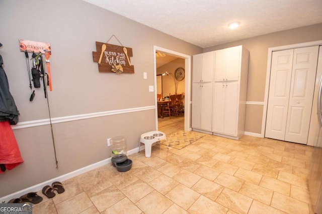 interior space with a closet and baseboards