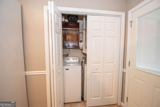 washroom featuring hookup for a washing machine and cabinet space