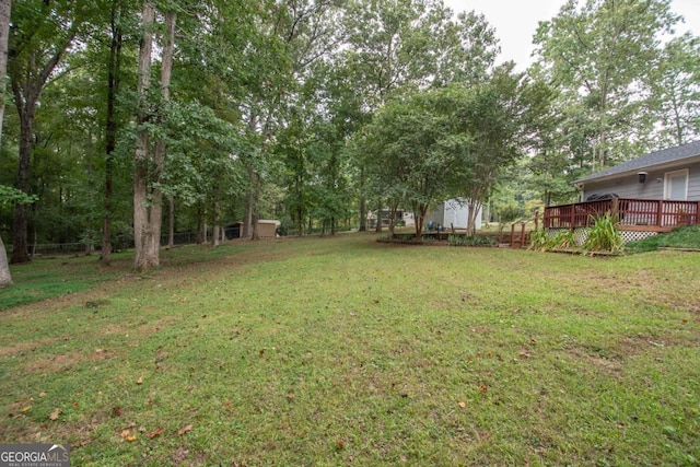 view of yard with a wooden deck