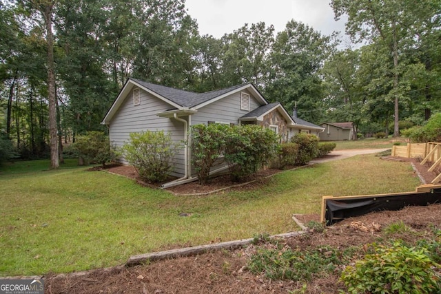 view of side of home with a lawn