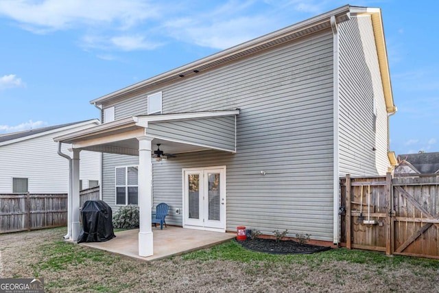 back of property with a yard, a patio, fence, and ceiling fan