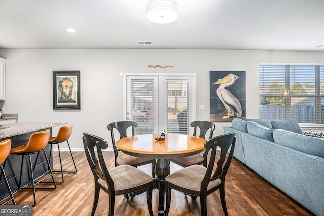 dining area with recessed lighting, visible vents, dark wood finished floors, and baseboards