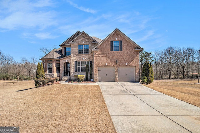 traditional home featuring brick siding, an attached garage, driveway, and a front lawn