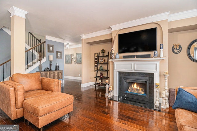 living area featuring baseboards, stairway, hardwood / wood-style floors, and ornamental molding