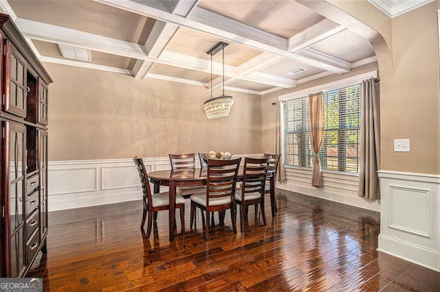 dining area featuring arched walkways, beam ceiling, dark wood-style flooring, a notable chandelier, and coffered ceiling