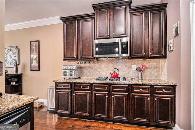 kitchen with baseboards, stainless steel appliances, backsplash, and light stone countertops