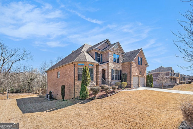 view of front of house with a garage, stone siding, concrete driveway, and brick siding