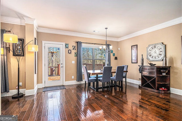 dining space featuring dark wood-style floors, baseboards, and crown molding