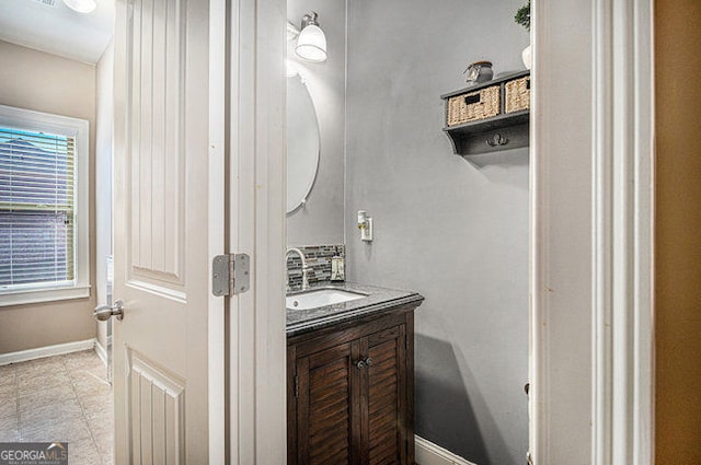 bathroom with vanity and baseboards