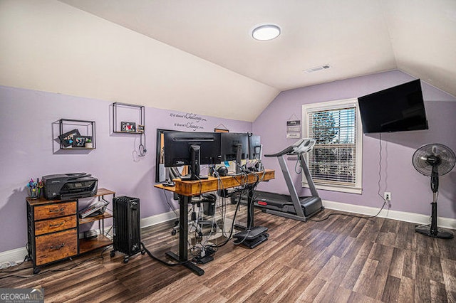 office space featuring lofted ceiling, wood finished floors, visible vents, and baseboards