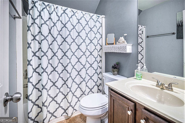 full bathroom featuring shower / bath combo with shower curtain, vanity, and toilet