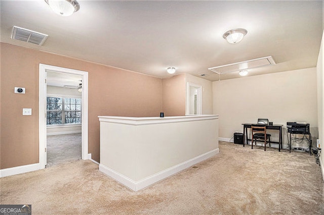 interior space with attic access, baseboards, visible vents, carpet flooring, and an upstairs landing