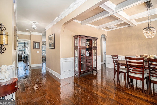 dining space featuring arched walkways, beam ceiling, crown molding, coffered ceiling, and hardwood / wood-style floors