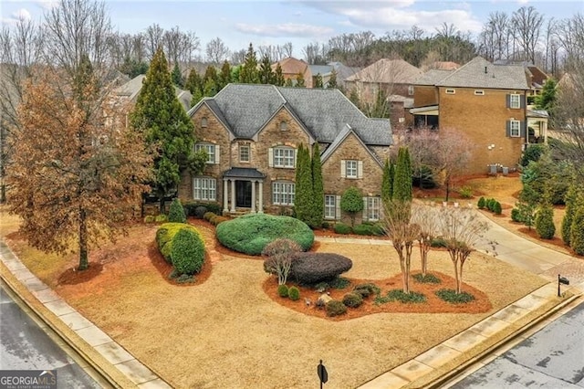 view of front facade featuring stone siding and driveway