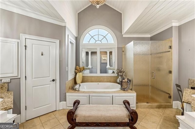 bathroom with a stall shower, ornamental molding, a garden tub, and tile patterned floors