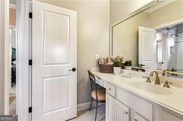 bathroom featuring tile patterned flooring, vanity, and baseboards