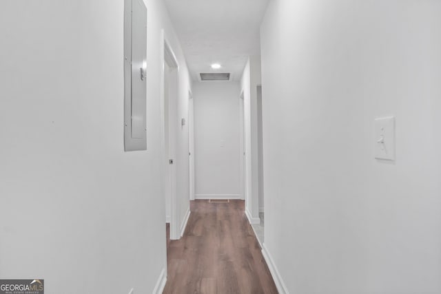 hall featuring dark wood-style floors, visible vents, attic access, electric panel, and baseboards