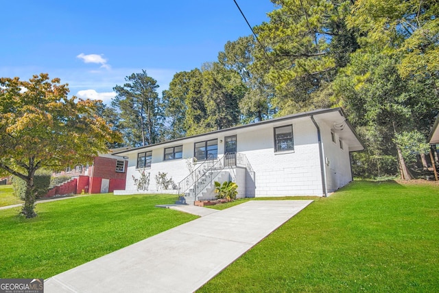 single story home featuring brick siding and a front yard