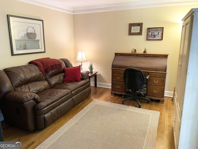 office area featuring baseboards, crown molding, and wood finished floors