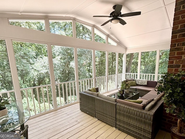 sunroom / solarium with lofted ceiling, plenty of natural light, and a ceiling fan