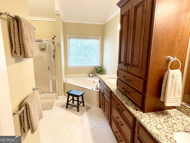 bathroom with a stall shower, crown molding, a bath, and vanity