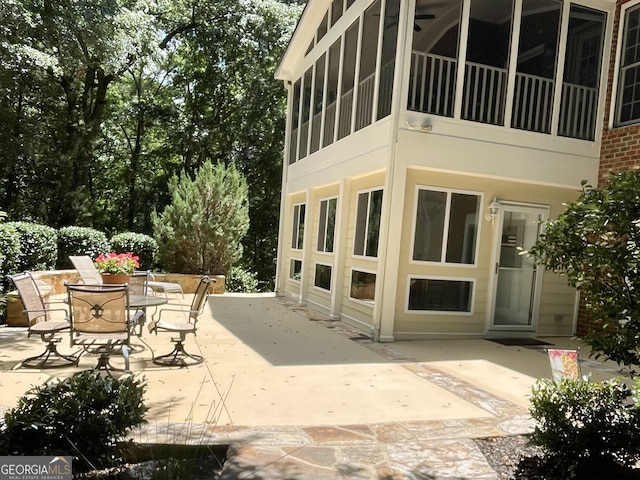 exterior space featuring a sunroom and a patio