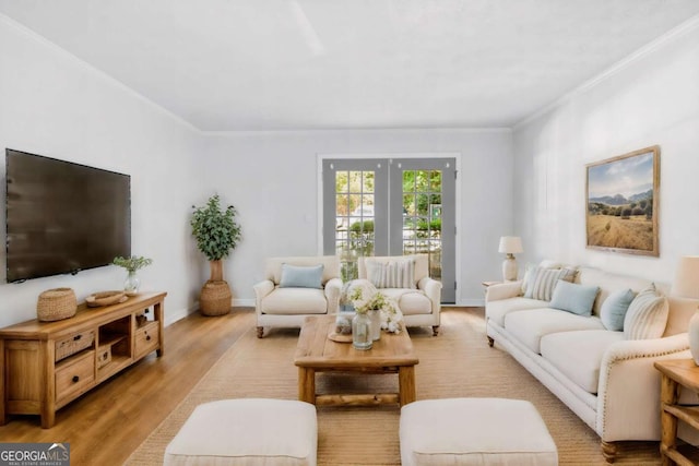 living room with crown molding, baseboards, and wood finished floors