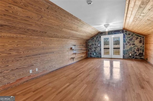 bonus room with wooden ceiling, wooden walls, vaulted ceiling, and wood finished floors