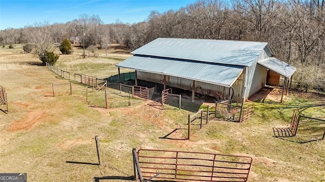 view of outbuilding with an exterior structure, a rural view, and an outdoor structure